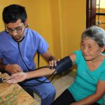 medical intern taking patient's blood pressure