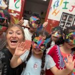 happy female volunteer with students