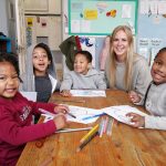 female volunteer with african students