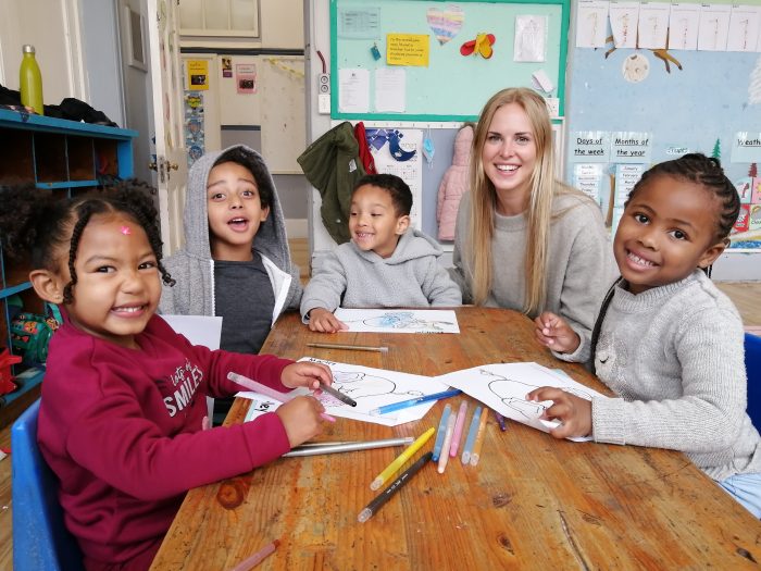 female volunteer with african students