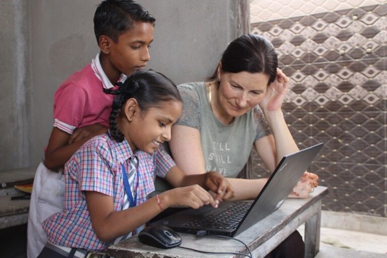 A volunteer teaching students at a school in Jaipur, India