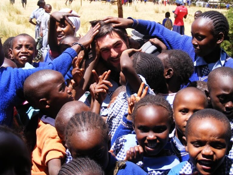 A gap year volunteer working with children in Kenya