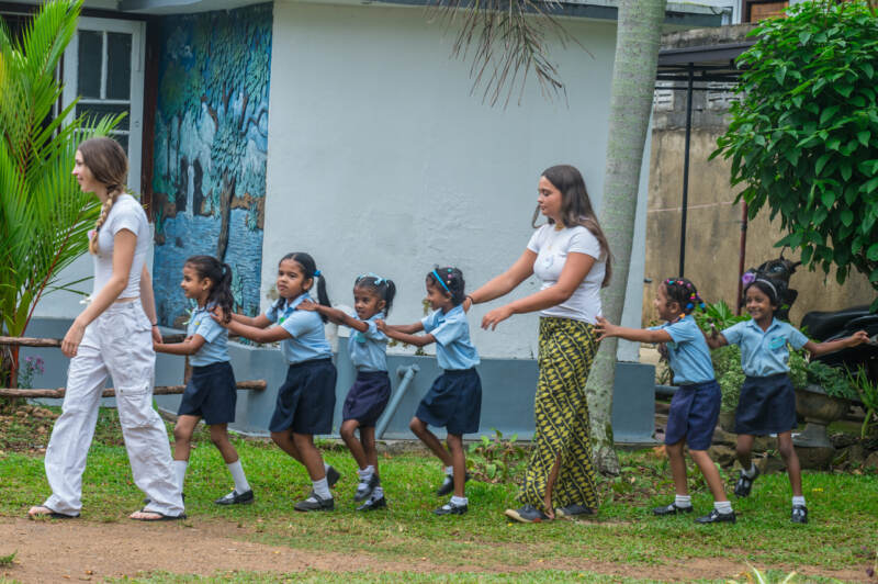 Volunteers playing with children at a kindergarten project