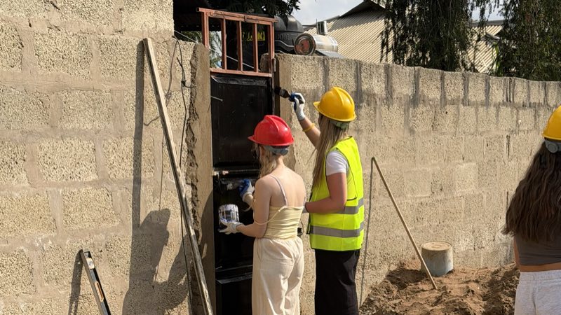 Volunteers in hard hats on a construction project